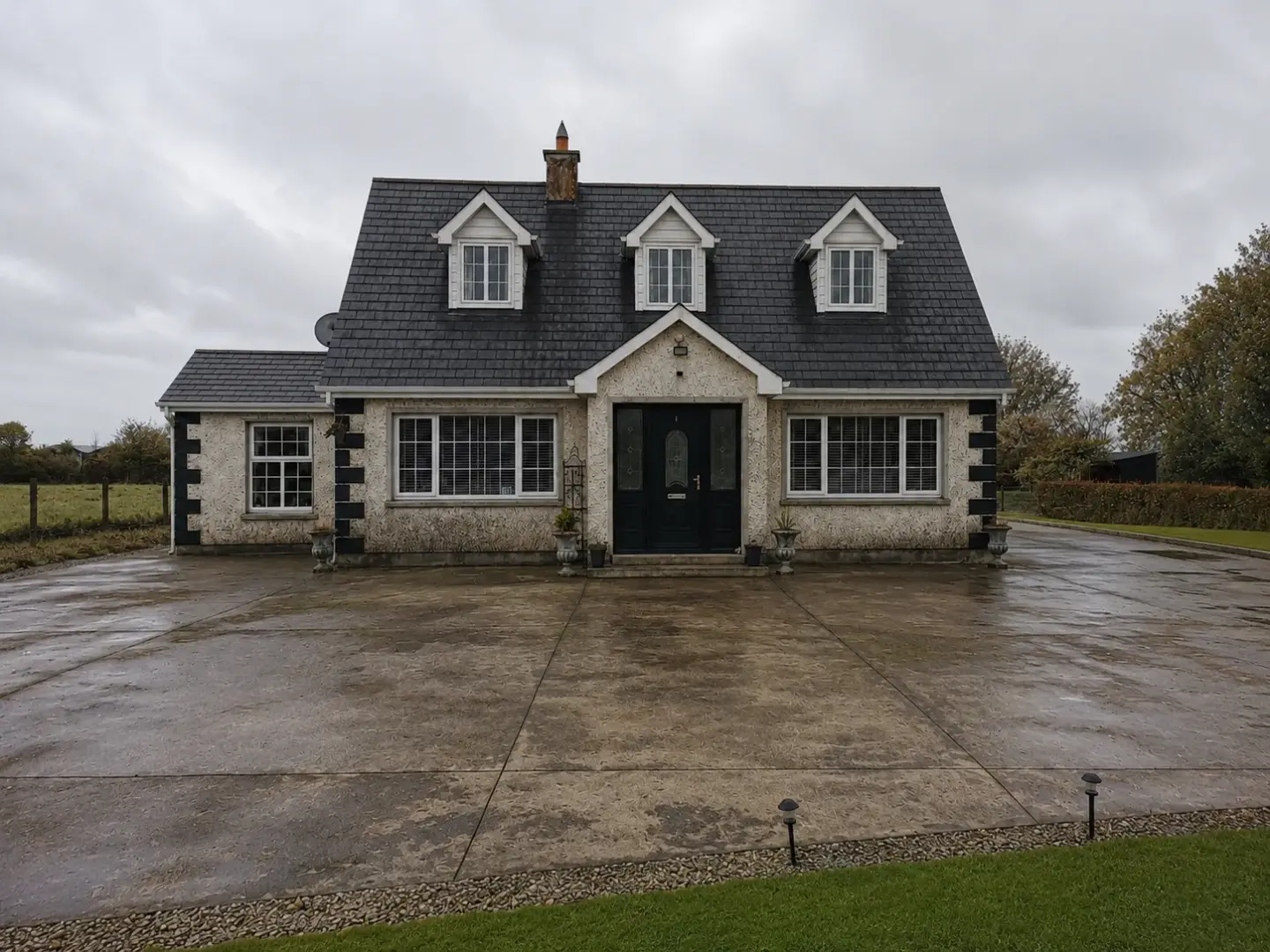 Concrete driveway before cleaning, dark with moss and grime