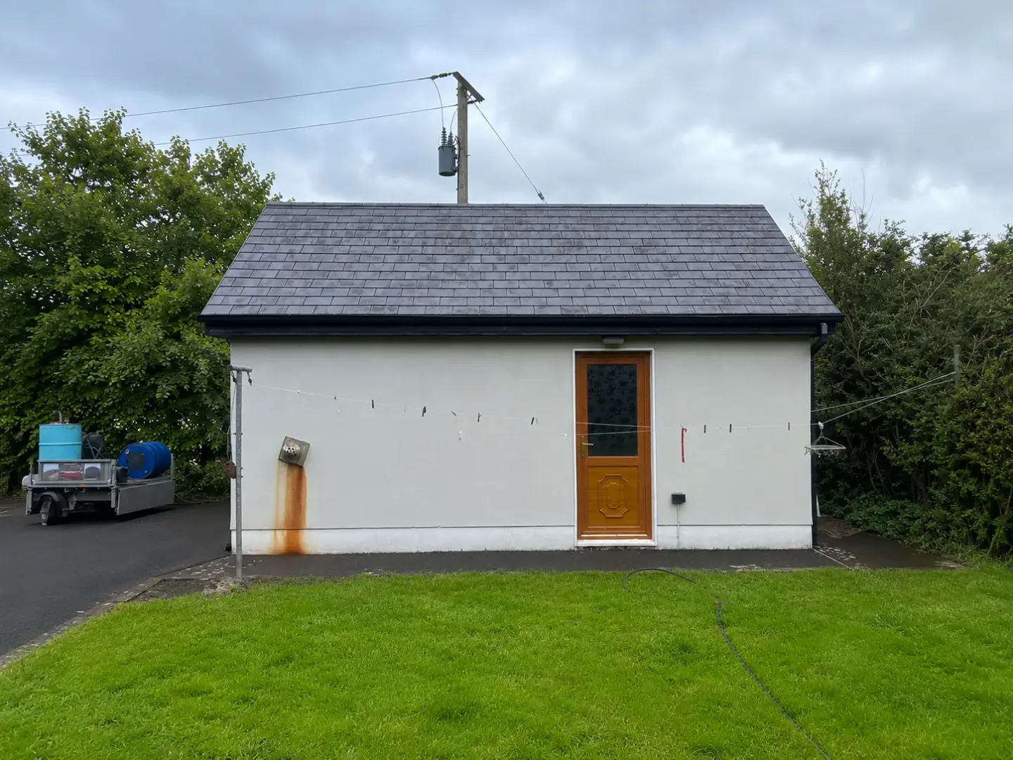 Exterior wall before gutter cleaning, marked by water staining